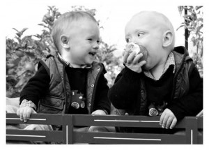 2 little boys, one eating an apple