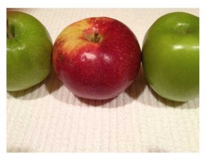 a row of apples, 2 green and one red