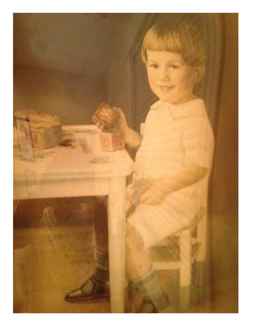 vintage photo of the author's father as a child playing with blocks